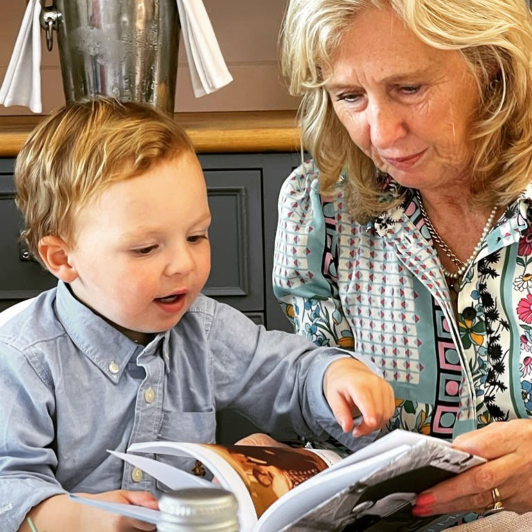 Grandmother and grandson looking at a great-grandmother's autobiography